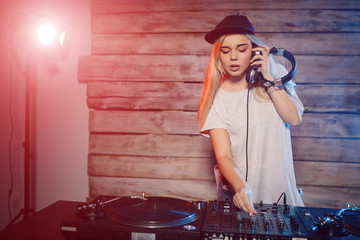 Cute dj woman having fun playing music at club party