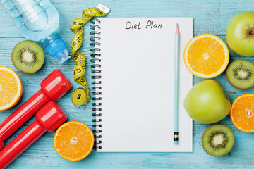 Diet plan, menu or program, tape measure, water, dumbbells and diet food of fresh fruits on blue...