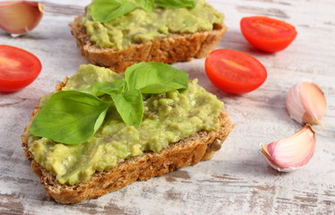 Freshly sandwiches with paste of avocado and ingredients, healthy food and nutrition