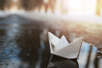 paper boat in a pool winter