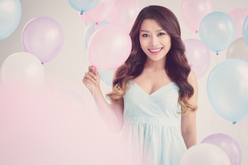 Beautiful Vietnamese young woman posing with balloon