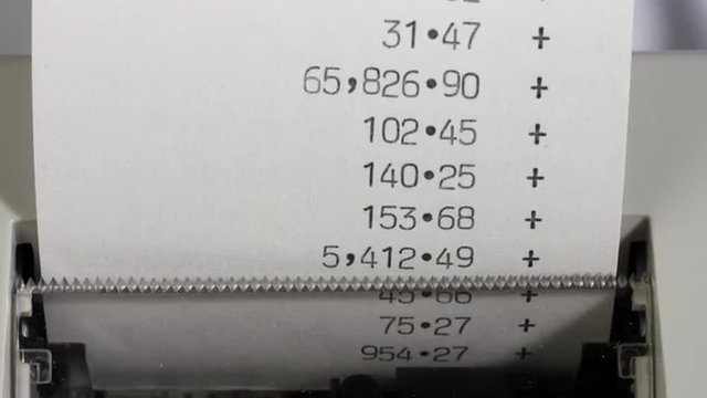 Fast moving office adding machine or calculator printout. Financial accounts and accounting. Time lapse zoom in.