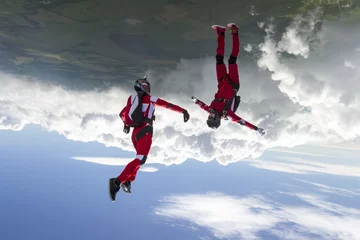 Fototapeten Two sports parachutist build a figure in free fall. © German Skydiver