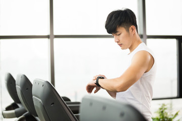 young handsome asian man works out in modern gym