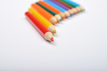 Close up picture of many little colored pencil crayons on white