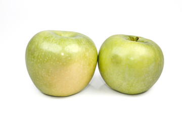 Whole green apple and half with leaf isolated on white backgroun