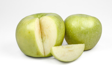 Whole green apple and half with leaf isolated on white backgroun