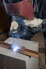 Welder working factory welding the metal