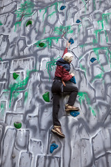 Obraz na płótnie Canvas Boy climber on a wall