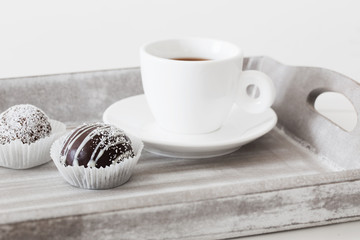 Sweet chocolate cake  with cup on wooden tray