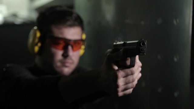 Aiming a pistol in a shooting range