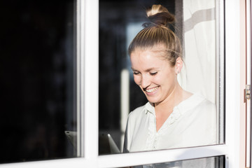 Woman sitting at Window with tablet