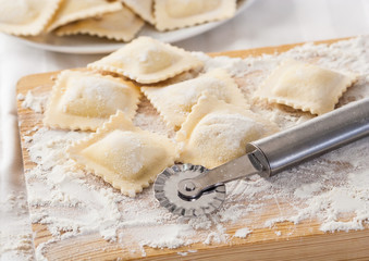 Making homemade Italian pasta ravioli with a cutting tool