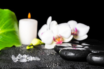 Obraz na płótnie Canvas beautiful spa setting of sea salt, black zen stones, white orchi