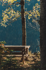 bench and table with a beautiful view of autumn in a mountain camping