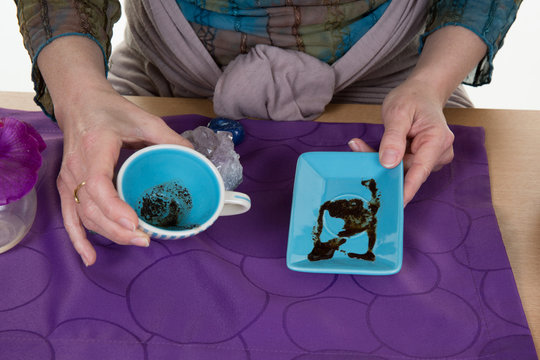 Fortune teller reading fortune on coffee grounds