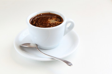 cup of coffee and silver spoon/cup of coffee and silver spoon on a white table