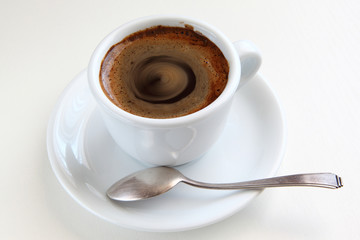 cup of coffee and silver spoon/cup of coffee and silver spoon on a white table
