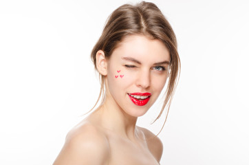 Obraz na płótnie Canvas Beauty model girl winks isolated over white