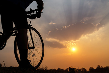 Silhouette of a bike on sky background on sunset