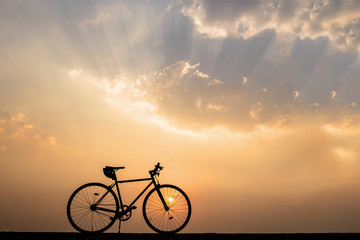 Silhouette of bicycle on nature at sunset
