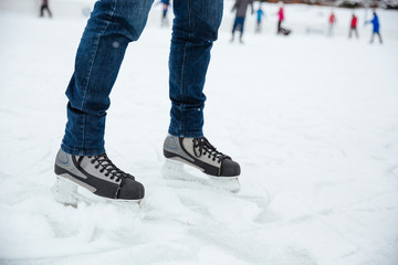 Man's legs in ice skates