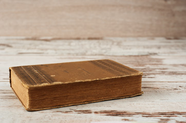 Closed old book. Wood Background