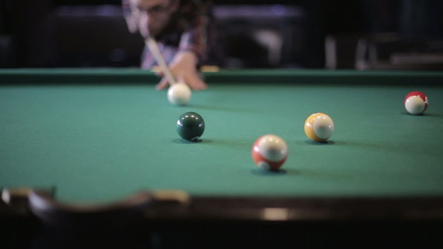 Friends are playing pool billiards