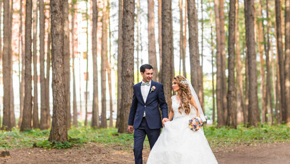 Happy bride and groom on their wedding day outdoors