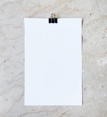 White sheet of paper lying on the marble background