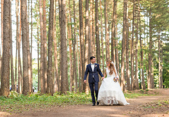 Happy bride and groom on their wedding day outdoors
