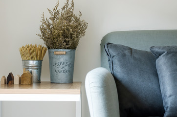 Modern sofa with dry flower in pot