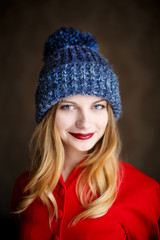 Portrait of playful woman in knitted winter cap