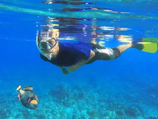 Deurstickers Asian snorkeler in the coral reef © Elya.Q