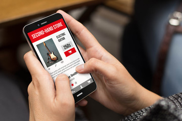 street girl buying in second-hand website with a smartphone
