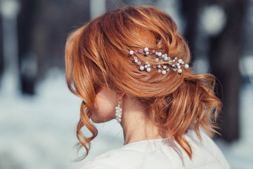 Back view of unrecognizable young woman with red hair in white 