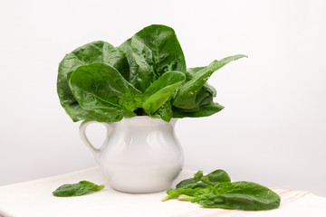 Still life composition with fresh spinach leaves 