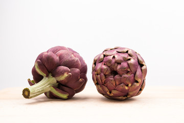 Fototapeta premium Artichokes with wooden kitchen board