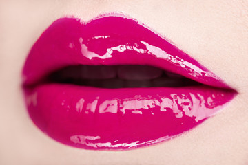 Close-up of woman pink lips with beautiful makeup.