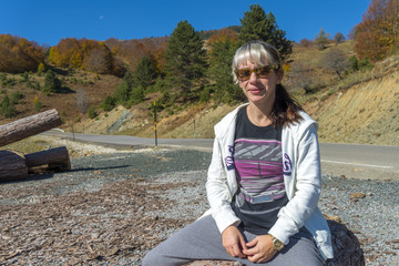 Young beautiful woman enjoying nature under the bright sunlight