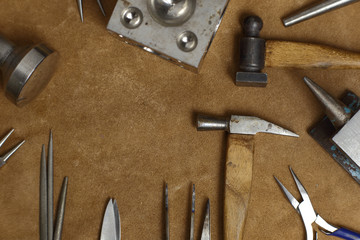 Tools of jewellery. Jewelry workplace on wooden background. Top view.