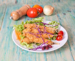 Fish fry in plate on wood desk