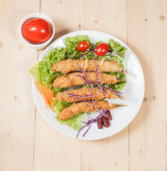 Fish fry in plate on wood desk