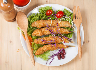 Fish fry in plate on wood desk