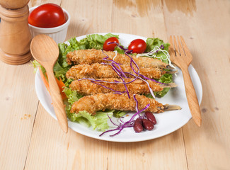 Fish fry in plate on wood desk