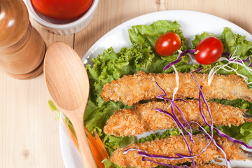 Fish fry in plate on wood desk