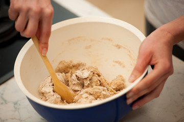 Kneading dough, preparing homemade bread out of spelt flour.