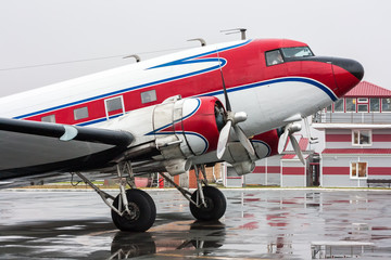 Retro plane on the rainy day at the airport