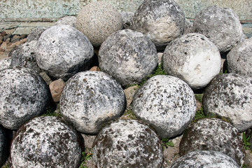 Old cannonballs, a core of ancient tools. Historical sites fortress Velikiy Novgorod, Russia. Stone cannon. Rare weapons of the Slavic wars.