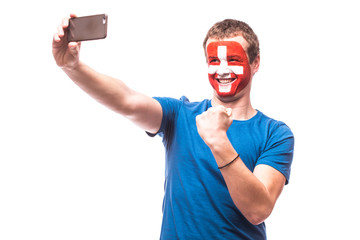 Swiss football fan take selfie photo with phone on white background. European 2016 football fans concept.